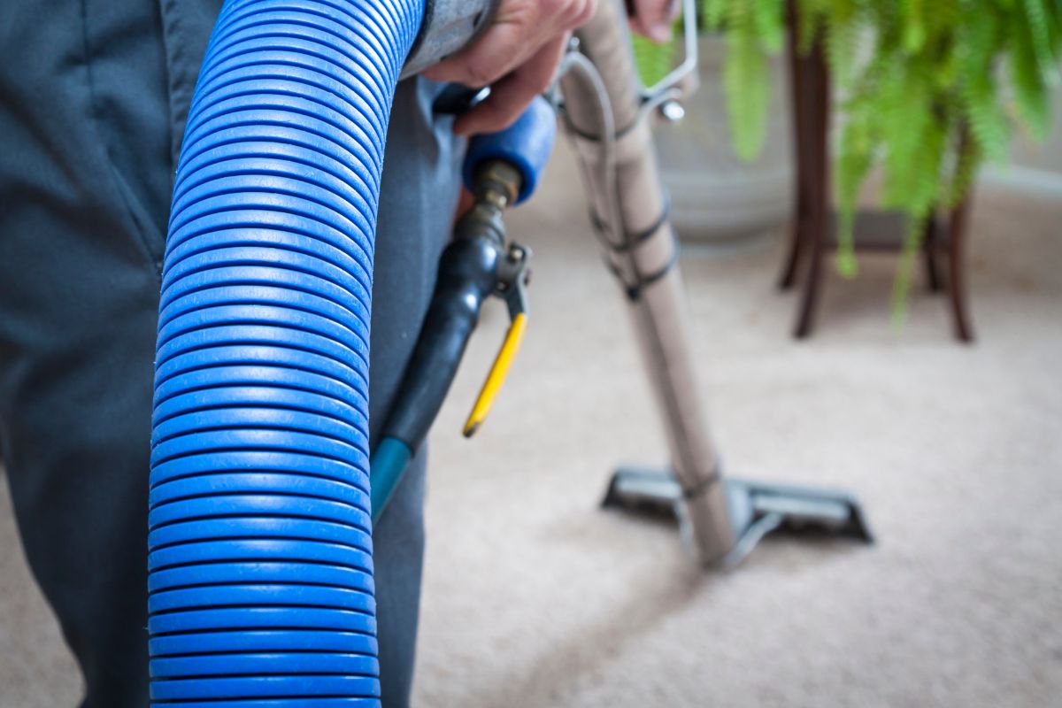Professional upholstery cleaning treating a fresh spill on a sofa