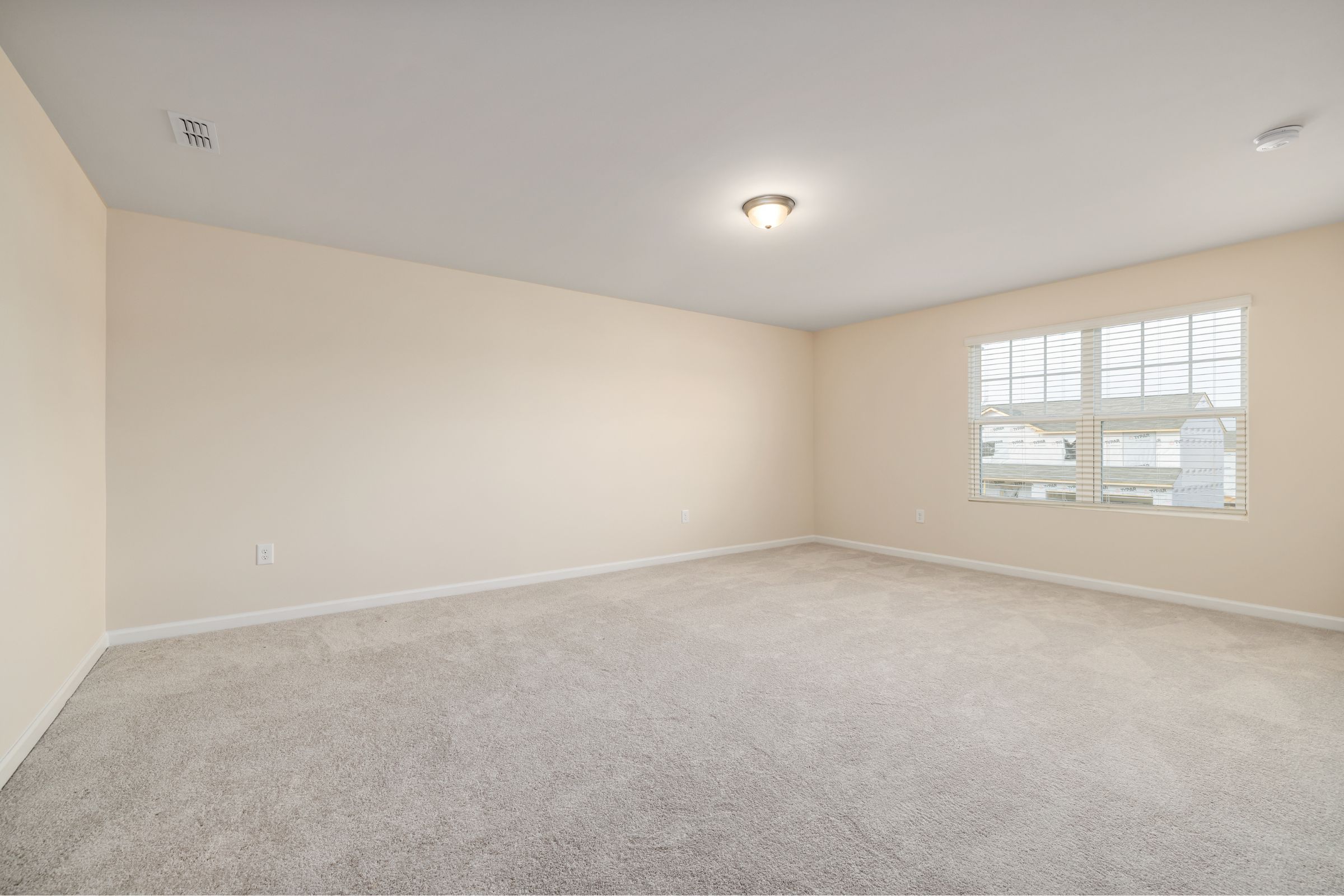 A freshly cleaned, inviting living-room sofa ready for guests